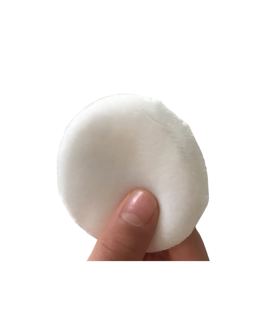 Smooth, soft, white makeup powder compact held in hand, perfect beauty companion.